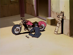 Wolfwood working on the red motorcycle.